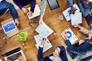 Image of Employers around table looking at documents